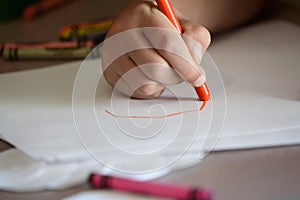 Child Coloring on Blank White Paper with Color Crayons