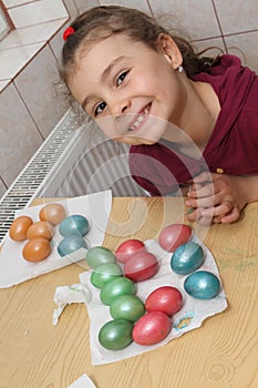 Child coloring easter eggs