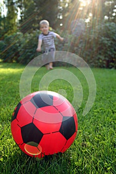Child concentrating to kick the ball