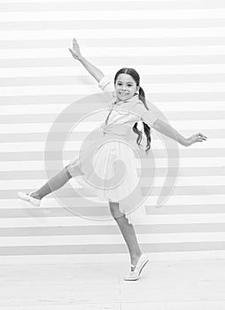 Child concept. Happy little child dancing. Child girl smile in fashion dress. Child and childhood. sense of freedom