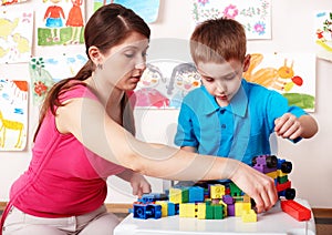 Child with construction in play room.