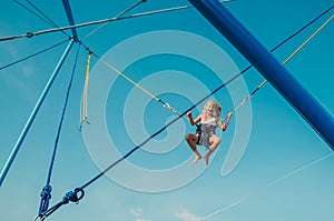 Child with courage jumping high up to the skies