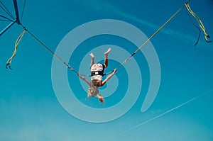 Child with courage jumping high up to the skies and spinning around