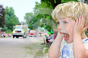 Child Covering Ears at Loud Parade