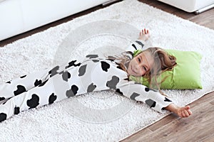 Child in cow print pajamas