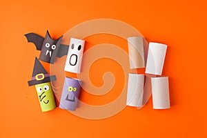 Child creates decorations for Halloween party from toilet roll. Easy eco-friendly DIY master class, craft for kids. Materials for