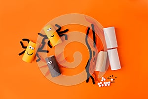 Child creates decorations for Halloween party from toilet roll. Easy eco-friendly DIY master class, craft for kids. Materials for