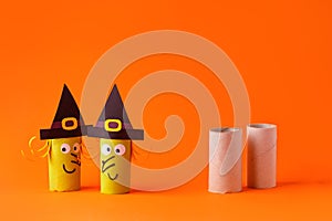 Child creates decorations for Halloween party from toilet roll. Easy eco-friendly DIY master class, craft for kids. Materials for