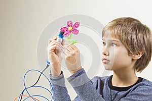 Child creating with 3D pen