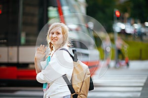 Child crossing crosswalk, hand waving and going to school