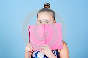 Child cute girl hold notepad or diary blue background. Childhood memories. Diary for girls concept. Note secrets down in