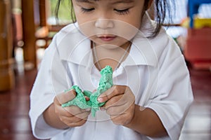 Child cute little girl playing with clay, play doh