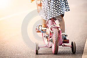 Child cute little girl riding bike
