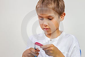 Child cutting colored paper with scissors