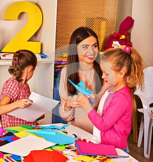 Child cutting paper in class. Development social origami lerning school.