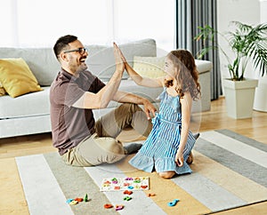 child daughter family happy father board game palying playing fun together girl cheerful home