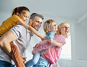 child daughter son family happy mother father sofa playing fun together girl boy cheerful smiling home together