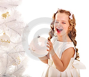 Child decorate Christmas tree.