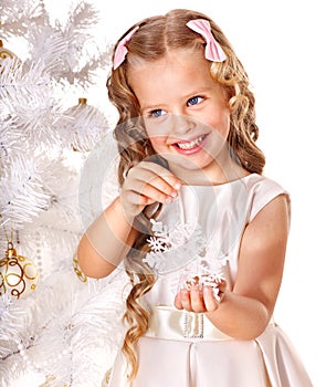 Child decorate Christmas tree.