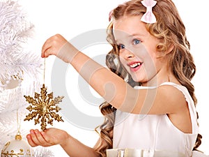 Child decorate Christmas tree. photo