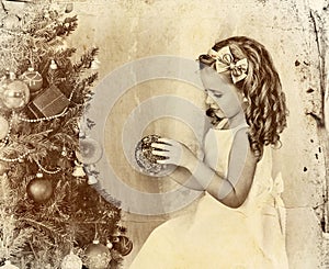 Child decorate Christmas tree . Old photo on yellow paper.