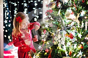 Child decorating Christmas tree