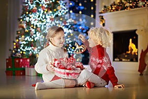 Kids decorate Christmas tree. Child on Xmas eve.