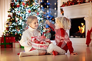 Kids decorate Christmas tree. Child on Xmas eve