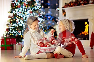 Kids decorate Christmas tree. Child on Xmas eve