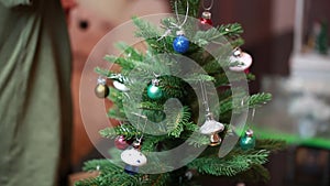 Child decorating toy Christmas tree. Christmas concept. Christmas background