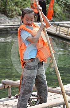 Child is delimiting the bamboo raft