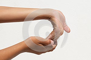 Child demonstrating palm flexibility by bending hand