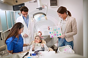 Child at dentist hold greenback for luck