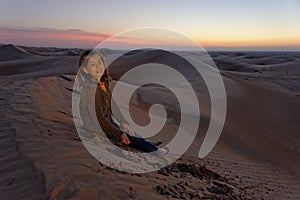 Child in desert at sunset
