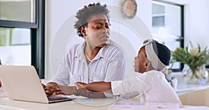 Child disturb mother on laptop for remote work, angry and girl wants attention in home at table. African mom, freelancer