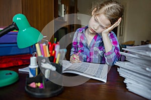 Child do his homework, writing and learning. Girl tired and scattered attention