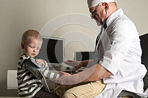 The child doctor examines the patients in his office. Happy children are very fond of a good pediatrician. The concept of a home d