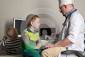 The child doctor examines the patients in his office. Happy children are very fond of a good pediatrician. The concept of a home d