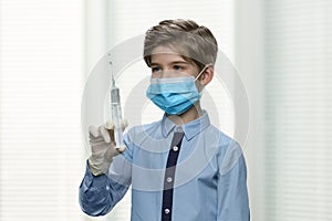 Child doctor preparing syringe for injection.