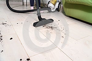 Child does cleaning with a vacuum cleaner