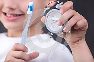 The child does a daily procedure to brushing his teeth