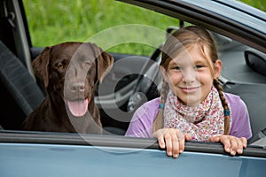 Child and dog in a car