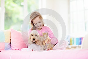 Child, dog and cat. Kids play with puppy, kitten