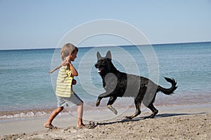 Child with dog outdoors on beach