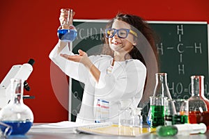 Child doing chemical research. Dangerous experiment