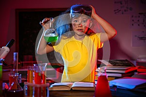 Child doing chemical research. Dangerous experiment