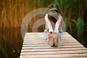 Child doing exercise on platform outdoors. Healthy lifestyle.