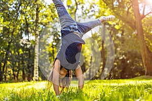 Child doing hand stand in park