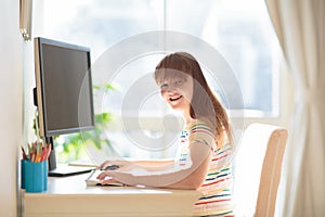 Child doing homework on computer. Online class