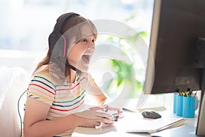 Child doing homework on computer. Online class